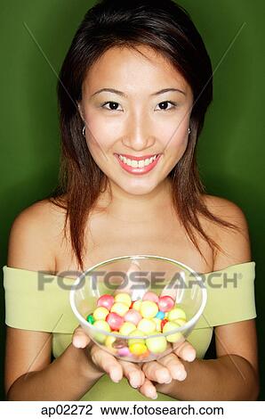 Woman with a bowl of candy View Large Photo Image Stock Image - Woman with a bowl of candy . Fotosearch