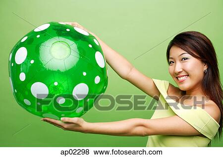 Woman with inflatable ball, arms outstretched View Large Photo Image Stock Photo - Woman with inflatable ball, arms outstretched . Fotosearch