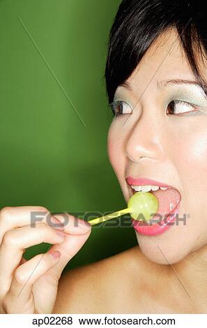 Woman with lollipop in mouth View Large Photo Image Stock Photo - Woman with lollipop in mouth . Fotosearch