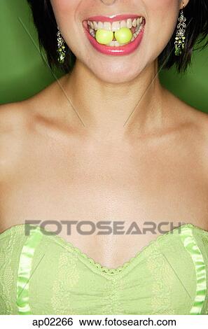 Woman with two sweets between teeth View Large Photo Image Stock Photograph - Woman with two sweets between teeth. Fotosearch