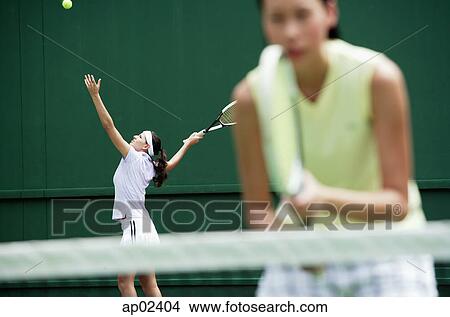 Women playing tennis together View Large Photo Image Picture - Women playing tennis together . Fotosearch