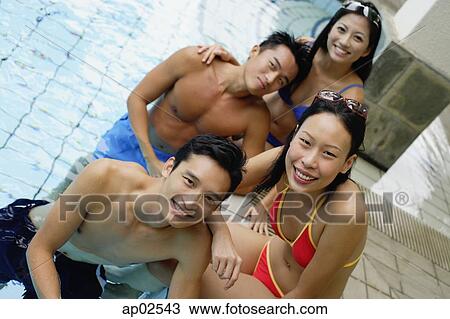 Young adult couples in swimming pool, smiling at camera, portrait View Large Photo Image Stock Image - Young adult couples in swimming pool, smiling at camera, portrait . Fotosearch