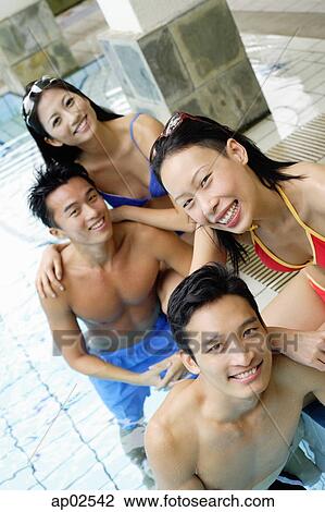 Young adults in swimming pool, smiling at camera View Large Photo Image Stock Image - Young adults in swimming pool, smiling at camera . Fotosearch