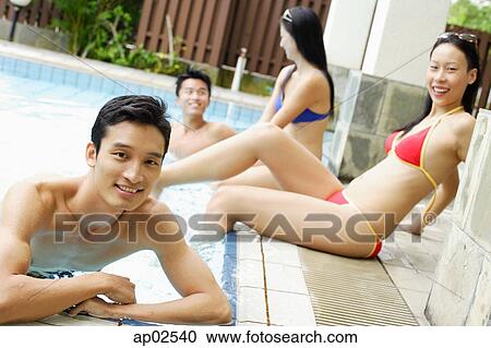 Stock Image - Young adults in swimming pool . Fotosearch