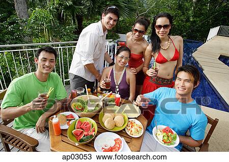 Young adults on patio, smiling at camera View Large Photo Image Stock Image - Young adults on patio, smiling at camera . Fotosearch