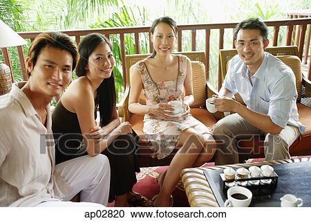 Young adults sitting and having coffee, portrait View Large Photo Image Stock Image - Young adults sitting and having coffee, portrait . Fotosearch