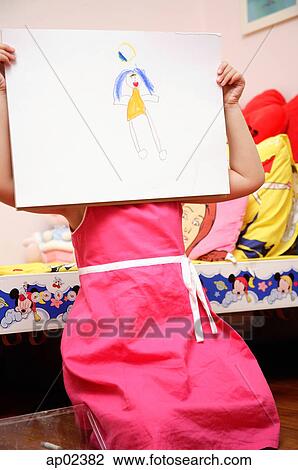 Young girl holding drawing over face View Large Photo Image Stock Image - Young girl holding drawing over face. Fotosearch