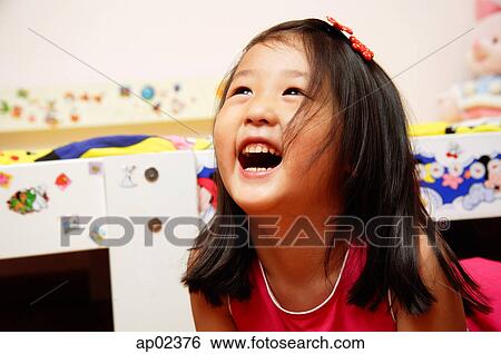Young girl looking up, laughing, portrait View Large Photo Image Stock Photograph - Young girl looking up, laughing, portrait. Fotosearch