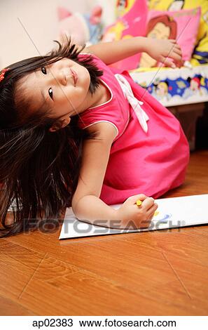 Young girl on floor, looking at camera View Large Photo Image Stock Image - Young girl on floor, looking at camera. Fotosearch