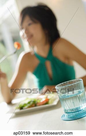Young woman eating salad, selective focus View Large Photo Image Stock Photo - Young woman eating salad, selective focus . Fotosearch