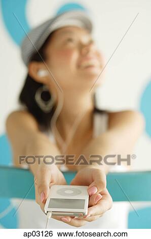 Young woman listening to MP3 player View Large Photo Image Stock Photograph - Young woman listening to MP3 player . Fotosearch