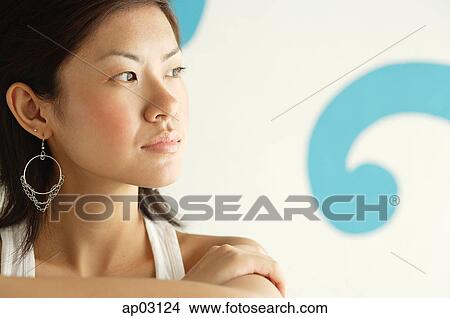 Picture - Young woman looking away, head shot . Fotosearch