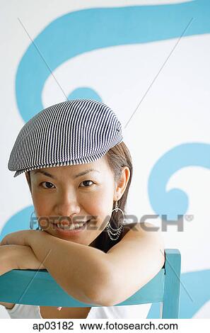 Stock Image - Young woman wearing beret, looking at camera . Fotosearch