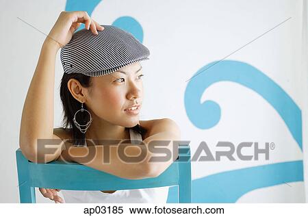 Young woman wearing beret, looking away, hand on head View Large Photo Image Stock Photography - Young woman wearing beret, looking away, hand on head . Fotosearch