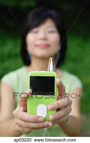 Young woman with mp3 player, eyes closed View Large Photo Image Stock Image - Young woman with mp3 player, eyes closed . Fotosearch