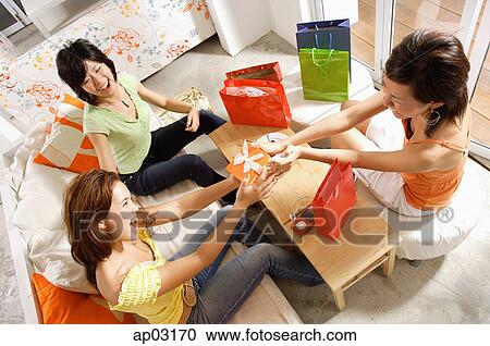 Stock Image - Young women at home, celebrating birthday . Fotosearch