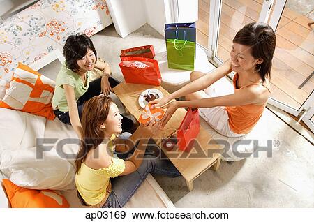 Young women at home, celebrating birthday View Large Photo Image Stock Photo - Young women at home, celebrating birthday . Fotosearch