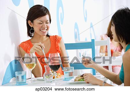 Young women having lunch in cafe View Large Photo Image Picture - Young women having lunch in cafe. Fotosearch