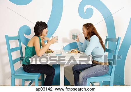 Young women having lunch in cafe View Large Photo Image Stock Image - Young women having lunch in cafe. Fotosearch