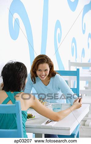 Young women in cafe View Large Photo Image Stock Photo - Young women in cafe. Fotosearch