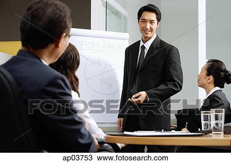 Executives having a business meeting, man giving presentation View Large Photo Image Stock Photo - Executives having a business meeting, man giving presentation. Fotosearch - Search Stock Images, Poster Photographs, Pictures, and Clip Art Photos