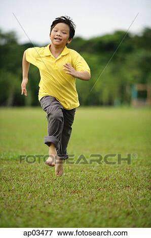 Boy running on grass View Large Photo Image Stock Photo - Boy running on grass . Fotosearch