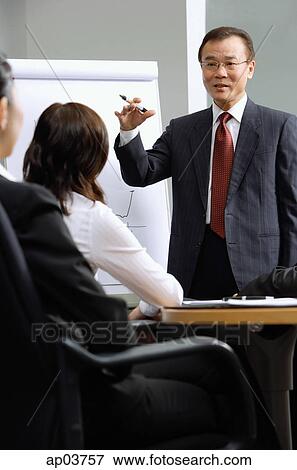 Stock Photo - Businessman giving presentation colleagues . Fotosearch