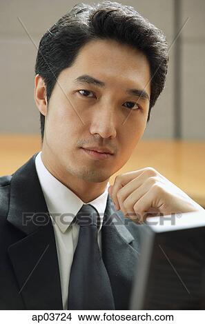 Picture - Businessman looking at camera. Fotosearch