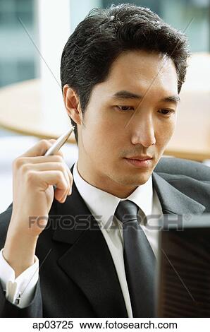 Businessman looking at computer monitor View Large Photo Image Stock Photography - Businessman looking at computer monitor . Fotosearch