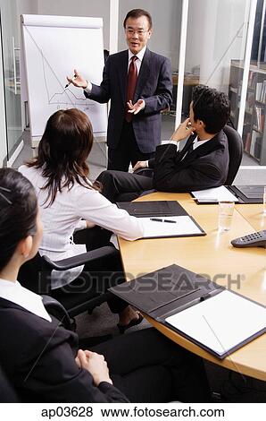 Businessman presenting to colleagues View Large Photo Image Stock Photo - Businessman presenting to colleagues . Fotosearch