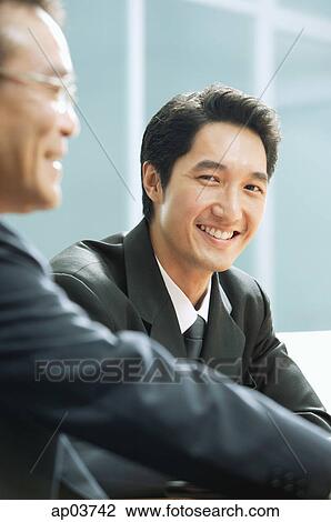 Businessman smiling, looking camera View Large Photo Image Stock Image - Businessman smiling, looking camera. Fotosearch