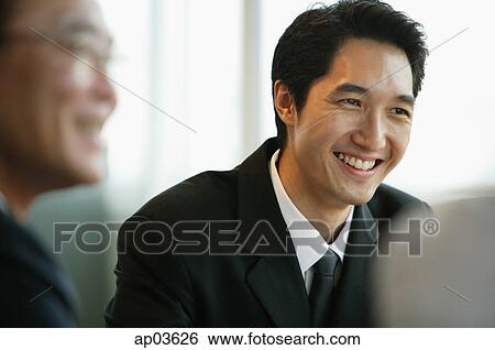 Businessman smiling, selective focus View Large Photo Image Stock Photograph - Businessman smiling, selective focus . Fotosearch