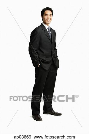 Businessman standing, hands in pocket View Large Photo Image Stock Photo - Businessman standing, hands in pocket. Fotosearch