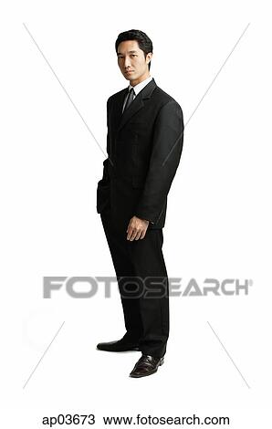 Stock Image - Businessman standing looking at camera . Fotosearch