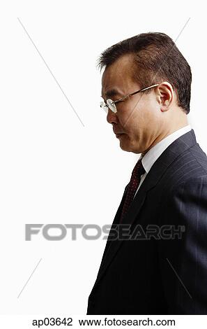 Businessman standing, side view View Large Photo Image Stock Image - Businessman standing, side view. Fotosearch