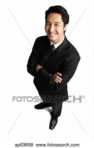 Businessman standing with arms crossed View Large Photo Image Stock Photo - Businessman standing with arms crossed. Fotosearch