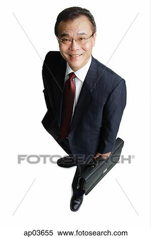 Businessman standing with hand in pocket, carrying briefcase View Large Photo Image Stock Photography - Businessman standing with hand in pocket, carrying briefcase . Fotosearch