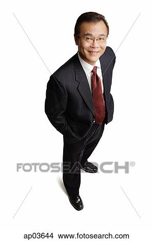 Businessman standing with hands in pocket, smiling at camera View Large Photo Image Picture - Businessman standing with hands in pocket, smiling at camera . Fotosearch