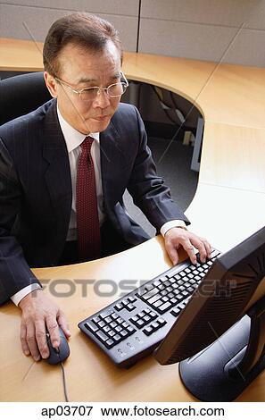 Businessman using computer View Large Photo Image Stock Photo - Businessman using computer. Fotosearch
