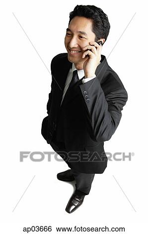 Businessman using mobile phone, smiling View Large Photo Image Stock Photograph - Businessman using mobile phone, smiling . Fotosearch