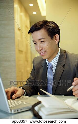 Stock Photo - Businessman working with laptop. Fotosearch