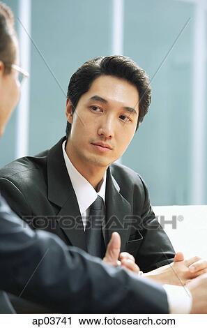 Businessmen sitting side by side View Large Photo Image Stock Image - Businessmen sitting side by side. Fotosearch