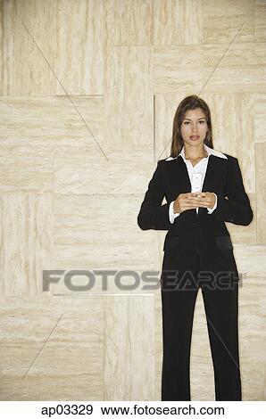 Stock Photo - Businesswoman holding mobile phone. Fotosearch