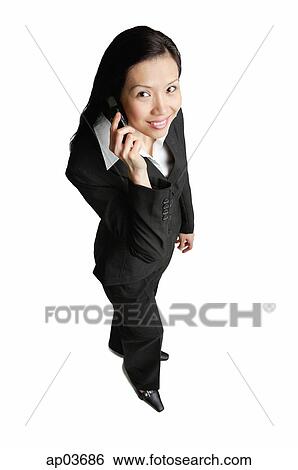 Businesswoman using mobile phone, looking at camera View Large Photo Image Stock Photograph - Businesswoman using mobile phone, looking at camera . Fotosearch