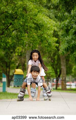 Stock Photo - Children skating, boy falling down . Fotosearch