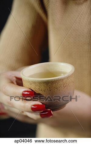 Close up of womans hands holding tea cup View Large Photo Image Stock Photograph - Close up of womans hands holding tea cup . Fotosearch