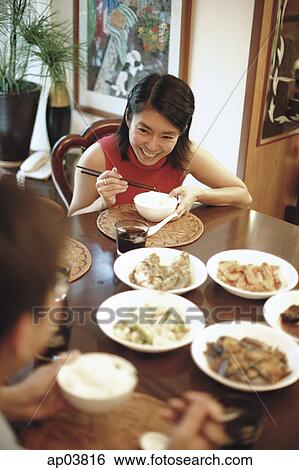 Stock Photograph - Couple eating at home . Fotosearch
