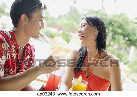 Stock Image - Couple having drinks. Fotosearch
