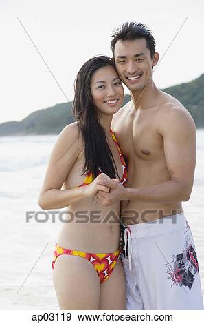 Couple holding hands, looking at camera View Large Photo Image Stock Photo - Couple holding hands, looking at camera . Fotosearch
