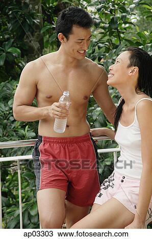 Couple in casual clothing, facing each other View Large Photo Image Stock Image - Couple in casual clothing, facing each other. Fotosearch